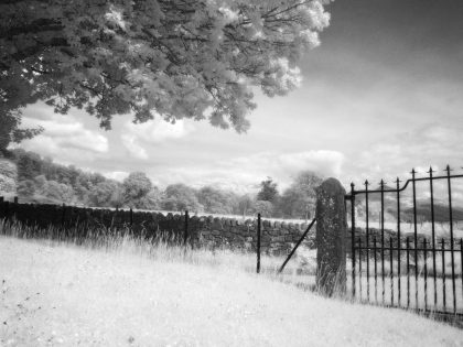 Ardchattan Priory ruins looking past gate to countryside and Ben Cruachan